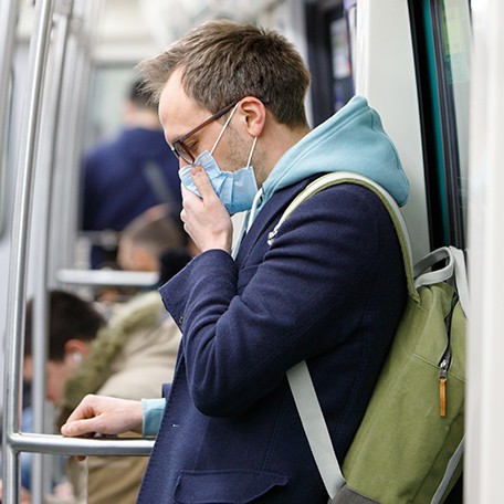 Man on subway wearing a facemask as US considers recommending masks to prevent spread of coronavirus